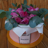Large flower box cake with piped edible flowers in pink and cream tones, styled like a gift box, serves 30–35, handmade in North London patisserie