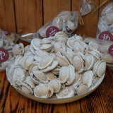Romanian Walnut Cookies filled with chocolate, rum, honey, and crushed walnuts, dusted with icing sugar.
