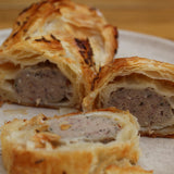 Twelve mini lamb sausage rolls in golden pastry with mint and cumin filling, Great Taste Award 2023 winner, handmade in North London bakery