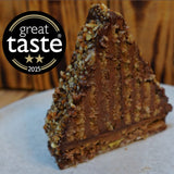 Mountain Cake with pecan and almond jaconde sponge layered with Belgian chocolate mousse. It's coated in honey chocolate ganache, handcrafted in North London