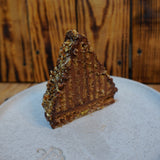 Mountain Cake with pecan and almond jaconde sponge layered with Belgian chocolate mousse. It's coated in honey chocolate ganache, handcrafted in North London