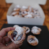 Mini plum frangipane tart canapés with almond cream filling, buttery pastry, and pistachio garnish, Great Taste Award 2022 winner, handmade in North London