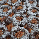 Flourless Walnetti cookies made with walnuts, cacao and egg, crisp and chewy, arranged on a tray at a North London patisserie