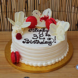 Personalised celebration cake with white chocolate flowers decoration at Prestige Patisserie