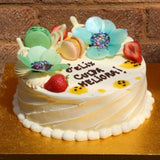 Personalised celebration cake with colourful chocolate flours decoration at Prestige Patisserie