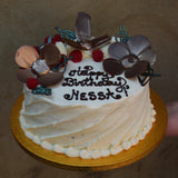 Prestige Patisserie whole cake with dark chocolate flowers design and fresh berries