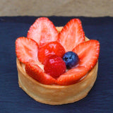 Individual sized Crostata tart with a golden sweet pastry crust and fresh fruit