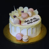 Prestige Patisserie birthday cake with chocolate white flowers design and chocolate drip and macarons