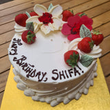 North London bakery’s signature whole cakes ready for collection with chocolate flowers and fresh berries