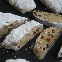 Handmade Christmas stollen with marzipan, cherries, and icing sugar from Prestige Patisserie.