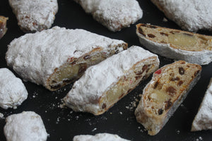 Handmade Christmas stollen with marzipan, cherries, and icing sugar from Prestige Patisserie.