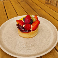 Individual sized Crostata tart with a golden sweet pastry crust and fresh fruit