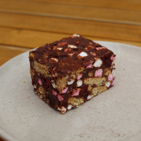 Close-up of a handmade Rocky Road bar with marshmallows and glace cherries by Prestige Patisserie