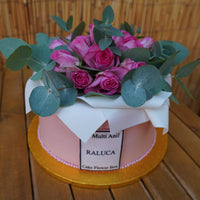 Large flower box cake with piped edible flowers in pink and cream tones, styled like a gift box, serves 30–35, handmade in North London patisserie