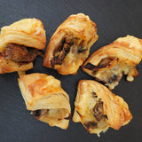 Golden baked pastry pockets filled with mushrooms, caramelised onions, and cheese, vegetarian canapés handmade in North London