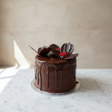 Close-up of a rich, layered chocolate cake with mousse and ganache finish