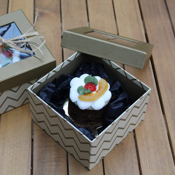 Mini brandy-soaked Christmas fruit cake in a luxury gift box, handmade by Prestige Patisserie.
