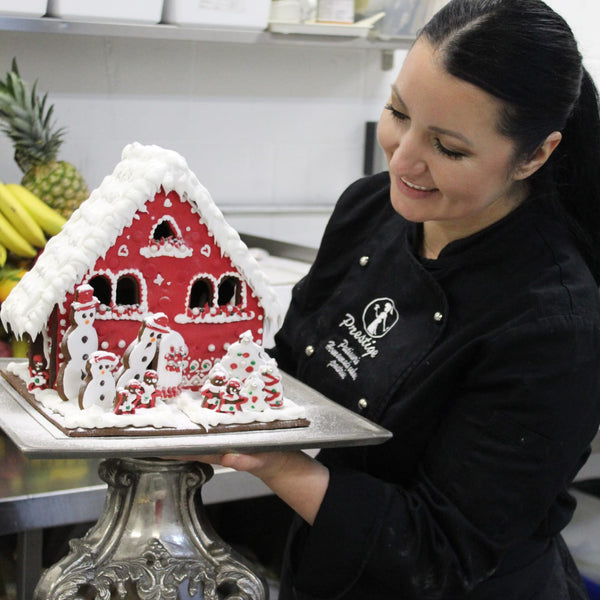 Prestige Patisserie showstopper gingerbread house in red icing gift box.