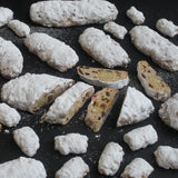 Handmade Christmas stollen with marzipan, cherries, and icing sugar from Prestige Patisserie.