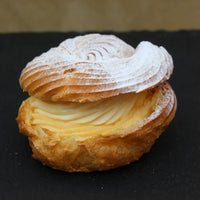 Choux à la Crème pastry filled with vanilla crème pâtissière and topped with cream cheese frosting, handcrafted in North London