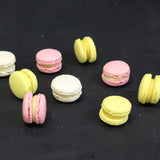 Box of 24 handmade passion fruit macarons with crisp almond shells and tropical ganache filling, flourless and freshly made in North London