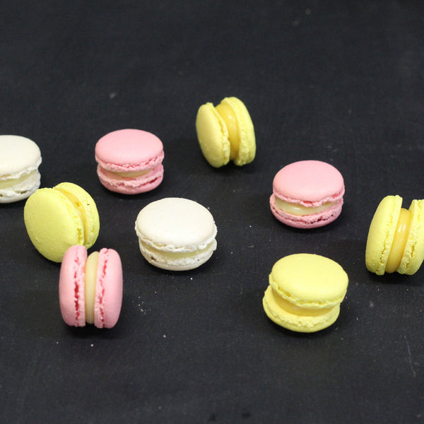 Box of 24 handmade passion fruit macarons with crisp almond shells and tropical ganache filling, flourless and freshly made in North London